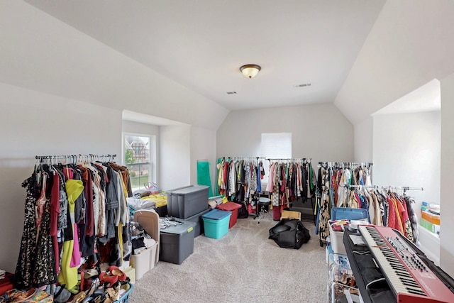 walk in closet with carpet, lofted ceiling, and visible vents