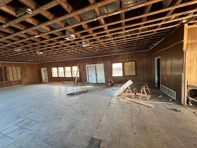 miscellaneous room featuring wood walls