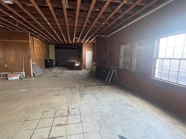 miscellaneous room with wooden walls and vaulted ceiling