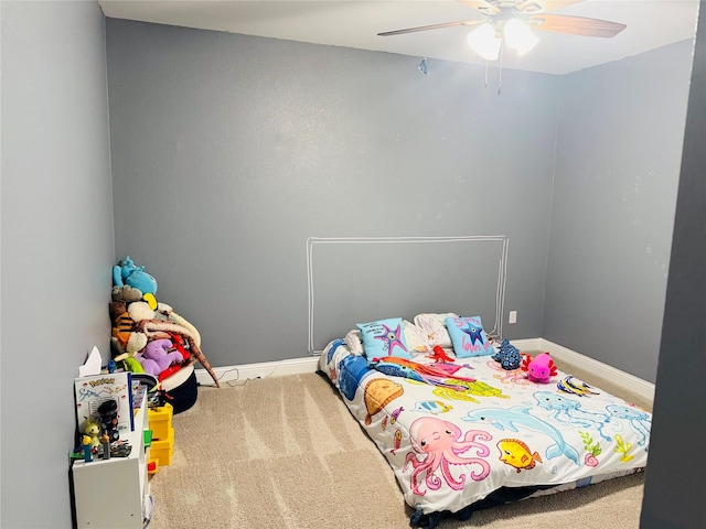 carpeted bedroom with baseboards and a ceiling fan