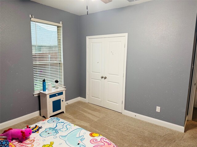 bedroom featuring baseboards and light carpet