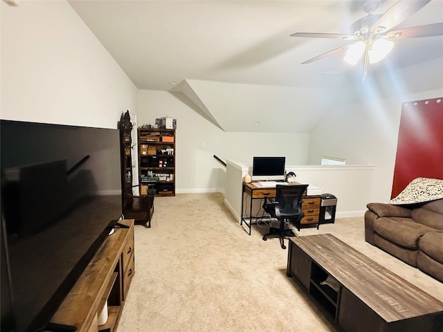 office space featuring a ceiling fan, baseboards, vaulted ceiling, and light carpet