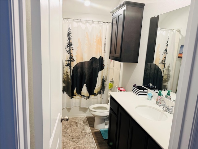 bathroom featuring vanity, a shower with shower curtain, wood finished floors, and toilet