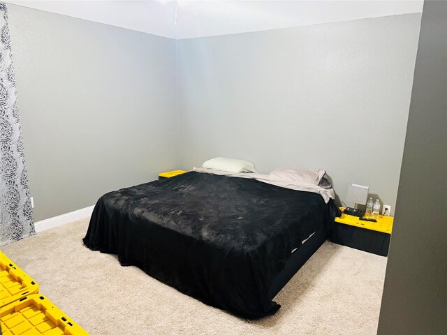 carpeted bedroom with baseboards
