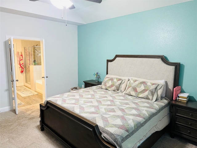 bedroom featuring carpet floors, ensuite bathroom, baseboards, and a ceiling fan