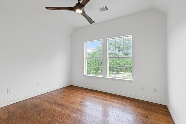 spare room with a ceiling fan, visible vents, wood finished floors, baseboards, and lofted ceiling