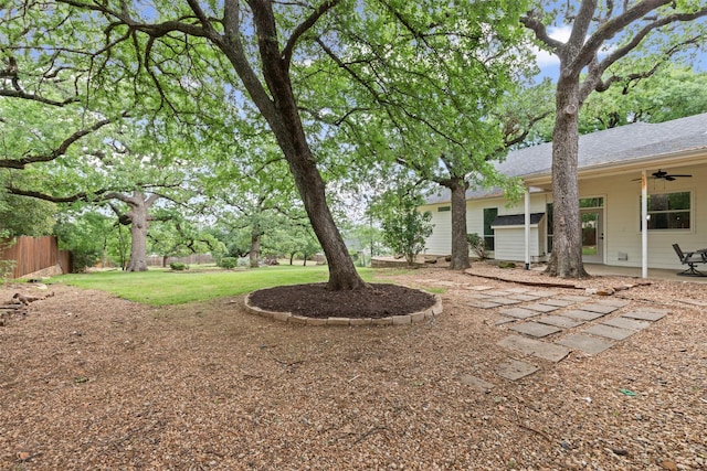 view of yard with fence, a patio, and ceiling fan