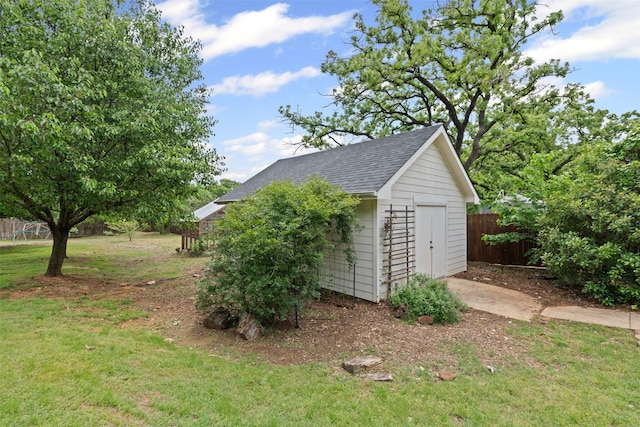 garage featuring a storage shed and fence