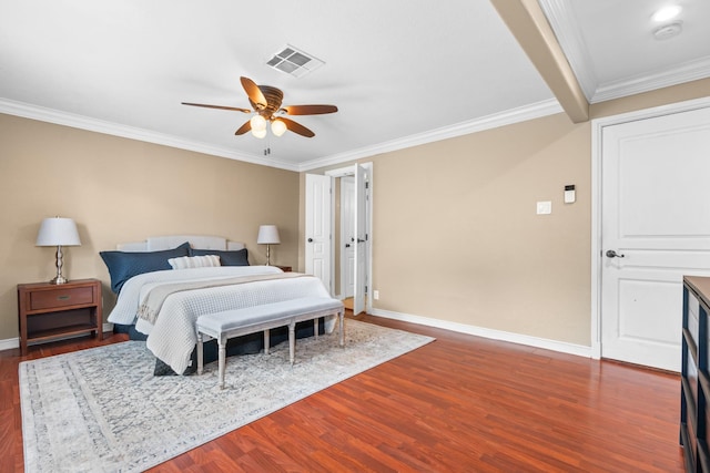 bedroom featuring dark wood-style floors, baseboards, visible vents, and ornamental molding