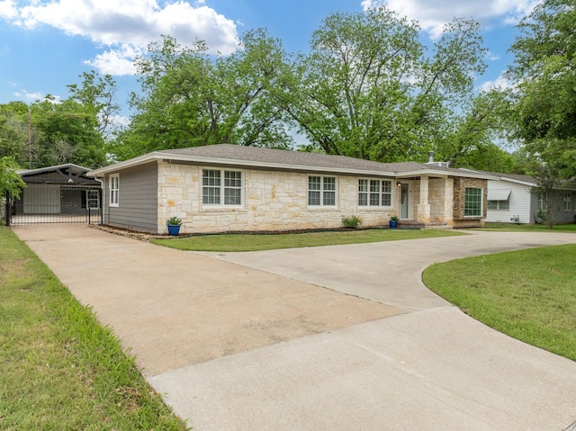 ranch-style house featuring driveway, a gate, stone siding, and a front lawn