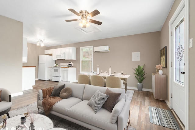 living room with baseboards, a wall unit AC, radiator heating unit, and light wood-style floors