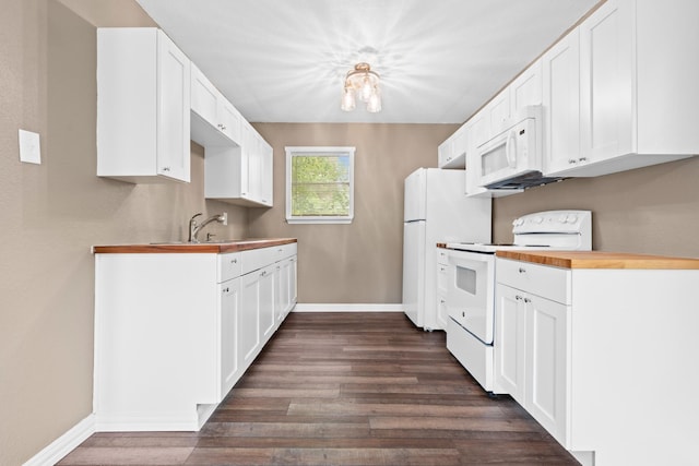 kitchen with a sink, baseboards, dark wood-style floors, white appliances, and white cabinetry