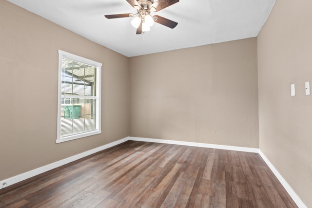 unfurnished room with a ceiling fan, baseboards, and wood finished floors