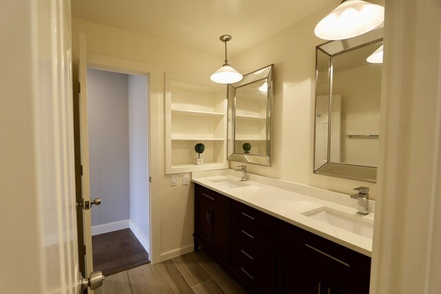 3509 Arbuckle Dr, Plano, TX 75075 - full bathroom with double vanity, baseboards, a sink, and wood finished floors