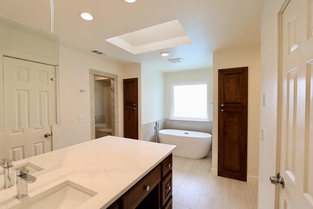 3509 Arbuckle Dr, Plano, TX 75075 - full bath featuring visible vents, a skylight, a freestanding bath, a shower stall, and vanity