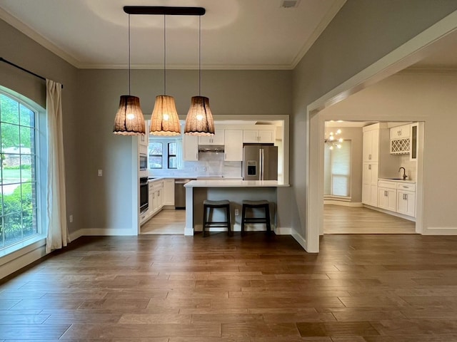 3509 Arbuckle Dr, Plano, TX 75075 - kitchen featuring backsplash, light countertops, white cabinets, ornamental molding, and stainless steel appliances