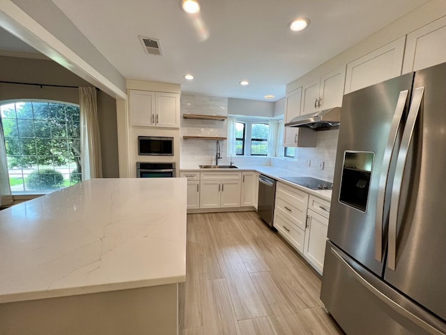 3509 Arbuckle Dr, Plano, TX 75075 - kitchen with visible vents, open shelves, under cabinet range hood, a sink, and appliances with stainless steel finishes
