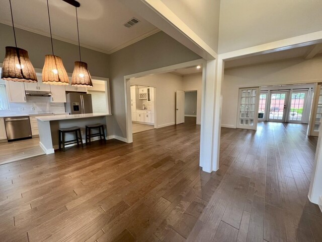 3509 Arbuckle Dr, Plano, TX 75075 - unfurnished living room featuring visible vents, ornamental molding, baseboards, dark wood-type flooring, and french doors
