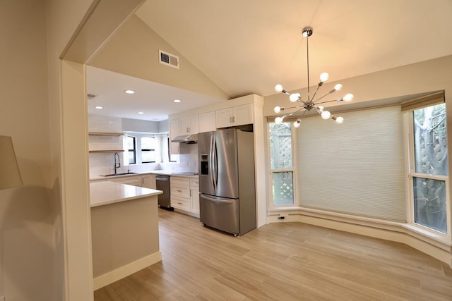 3509 Arbuckle Dr, Plano, TX 75075 - kitchen with under cabinet range hood, stainless steel appliances, visible vents, and plenty of natural light