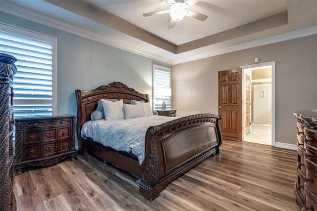 3788 Zion Rd, Garland, TX 75043 - bedroom with ceiling fan, ensuite bath, wood finished floors, a tray ceiling, and ornamental molding