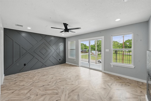 empty room featuring visible vents, baseboards, ceiling fan, recessed lighting, and a textured ceiling