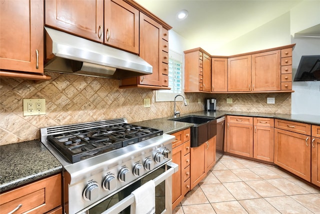 kitchen with appliances with stainless steel finishes, brown cabinetry, and under cabinet range hood