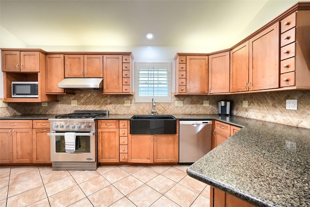 kitchen featuring a sink, stainless steel appliances, brown cabinets, and under cabinet range hood