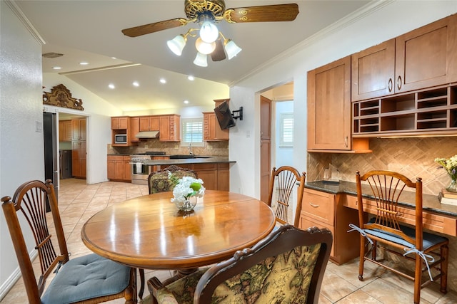 dining room featuring ceiling fan, visible vents, crown molding, vaulted ceiling, and light tile patterned flooring