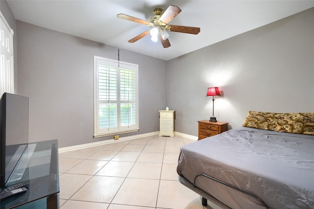 bedroom featuring baseboards, ceiling fan, and light tile patterned floors