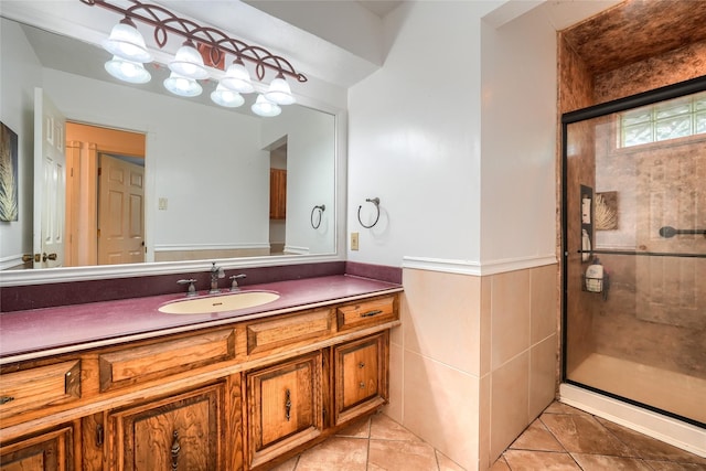 full bathroom with tile patterned flooring, a stall shower, and vanity