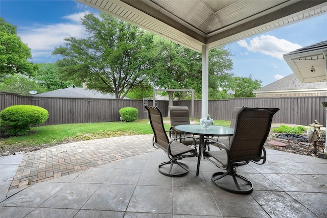 view of patio featuring a fenced backyard and outdoor dining area