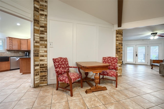 dining room featuring vaulted ceiling with beams, ceiling fan, light tile patterned flooring, and a healthy amount of sunlight