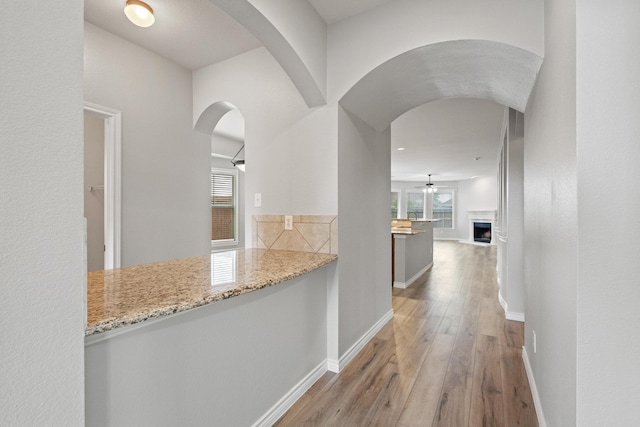 689 Bonham Dr, Lavon, TX 75166 - hallway with baseboards, arched walkways, and wood finished floors