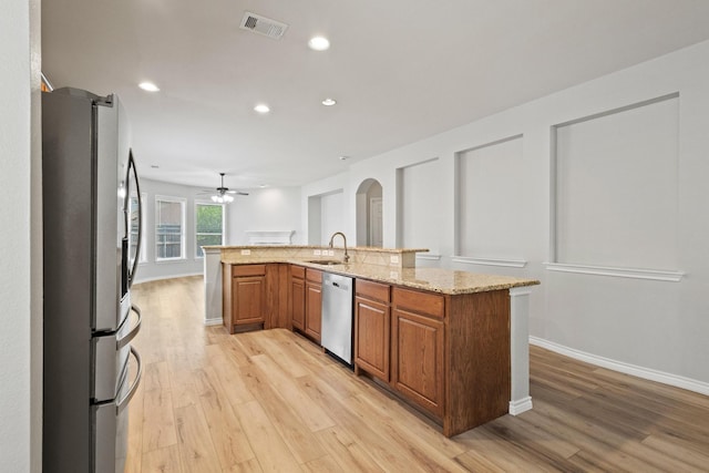 689 Bonham Dr, Lavon, TX 75166 - kitchen with visible vents, arched walkways, a sink, light wood finished floors, and stainless steel appliances