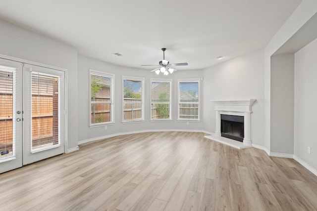 689 Bonham Dr, Lavon, TX 75166 - unfurnished living room with visible vents, baseboards, ceiling fan, a fireplace with raised hearth, and light wood-style flooring