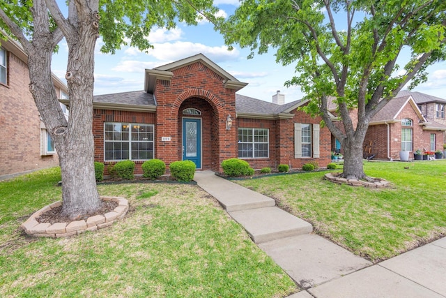 689 Bonham Dr, Lavon, TX 75166 - view of front of home with brick siding, a front lawn, roof with shingles, and a chimney