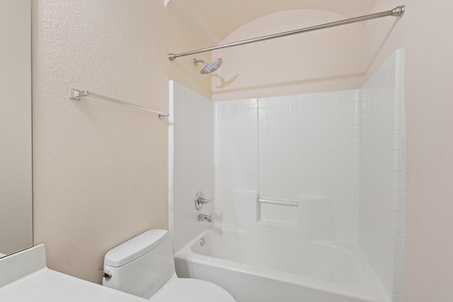 689 Bonham Dr, Lavon, TX 75166 - bathroom featuring toilet, a textured wall, and shower / bath combination