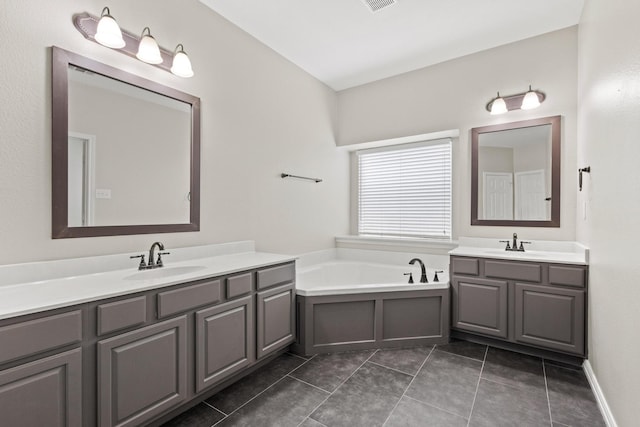 689 Bonham Dr, Lavon, TX 75166 - bathroom featuring a garden tub, a sink, two vanities, and tile patterned flooring