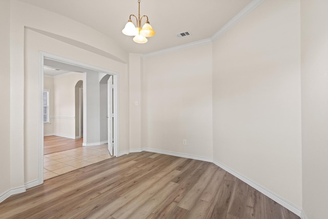 689 Bonham Dr, Lavon, TX 75166 - empty room with visible vents, arched walkways, a notable chandelier, ornamental molding, and light wood-style flooring