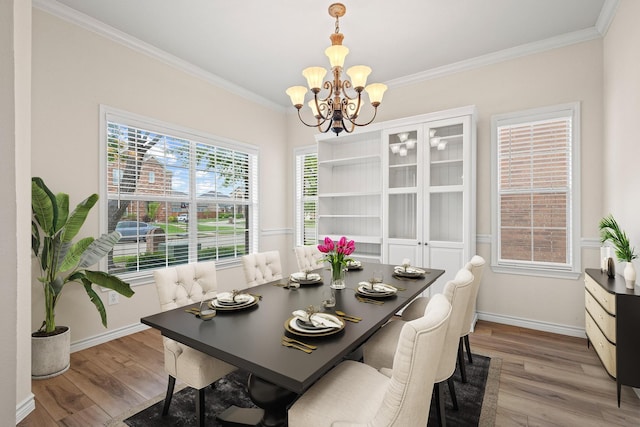 689 Bonham Dr, Lavon, TX 75166 - dining space featuring baseboards, an inviting chandelier, ornamental molding, and wood finished floors