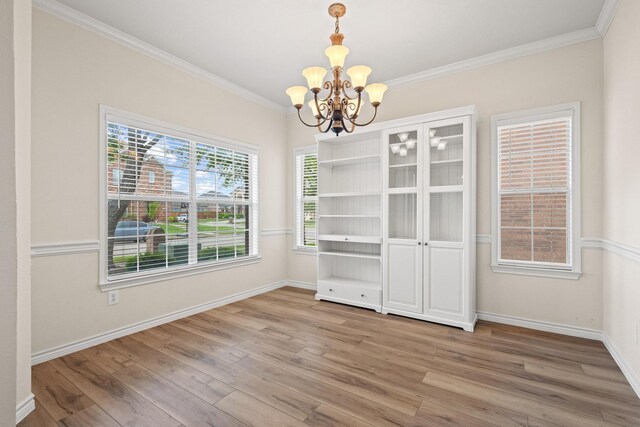 689 Bonham Dr, Lavon, TX 75166 - unfurnished dining area with light wood-style floors, ornamental molding, baseboards, and a chandelier