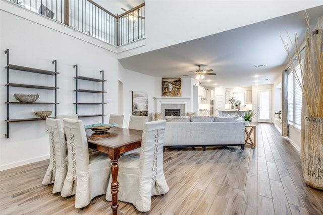 1213 Shire, Aubrey, TX 76227 - dining room with baseboards, a ceiling fan, wood finished floors, and a tile fireplace