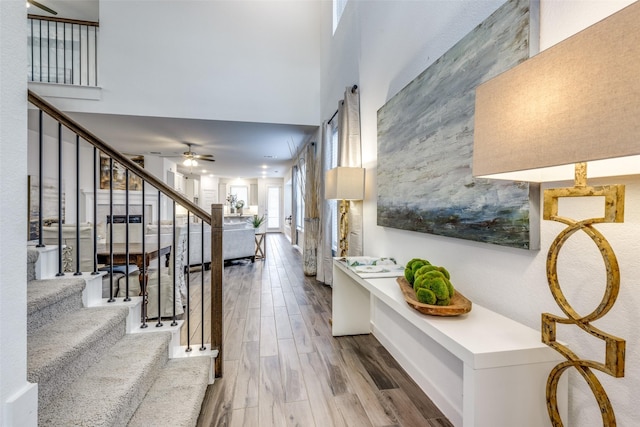 1213 Shire, Aubrey, TX 76227 - entryway featuring a ceiling fan, stairs, wood finished floors, and a high ceiling