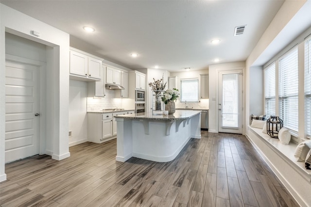1213 Shire, Aubrey, TX 76227 - kitchen featuring decorative backsplash, stainless steel appliances, visible vents, and dark wood-style floors