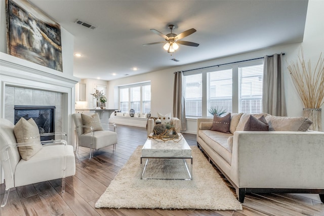 1213 Shire, Aubrey, TX 76227 - living room featuring ceiling fan, recessed lighting, wood finished floors, a tile fireplace, and visible vents