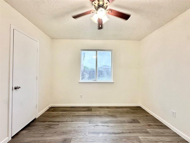 unfurnished bedroom featuring baseboards, a ceiling fan, a textured ceiling, and wood finished floors