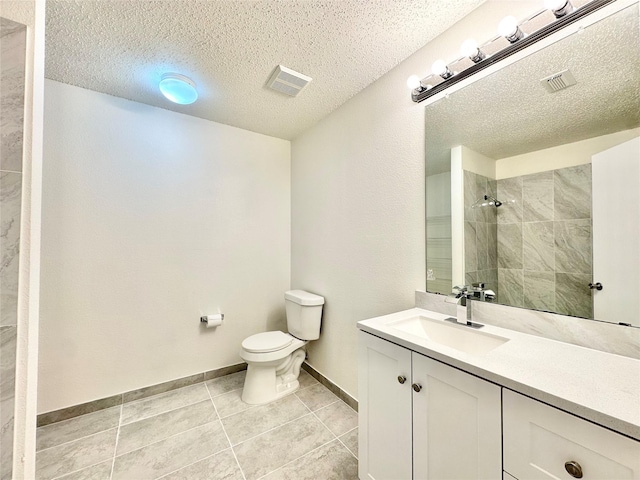 full bath featuring vanity, visible vents, toilet, tiled shower, and a textured ceiling