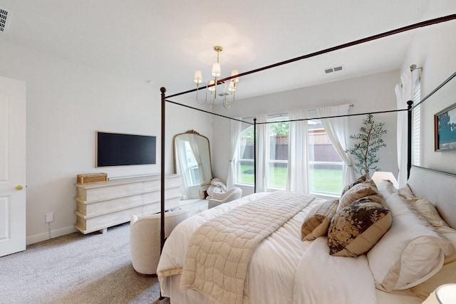 carpeted bedroom with visible vents, baseboards, and a chandelier