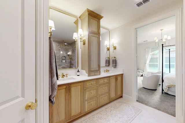 ensuite bathroom with a sink, ensuite bath, double vanity, and visible vents