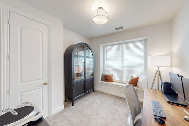 carpeted office with visible vents and baseboards